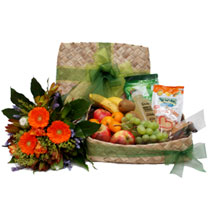 fruit and snacks in a flax box with flowers